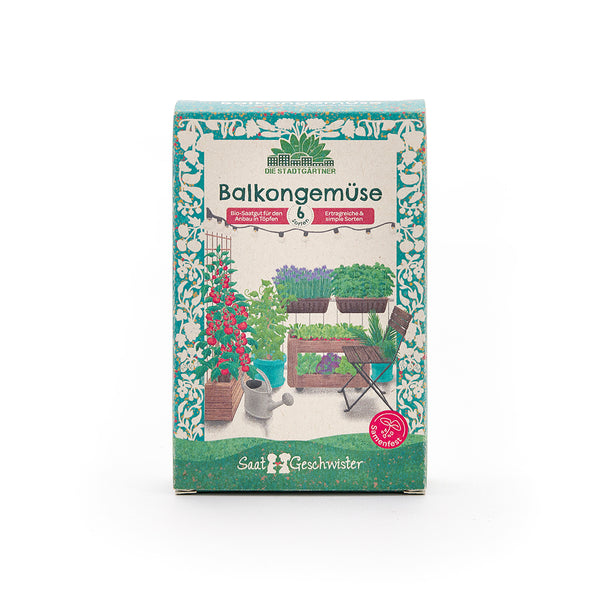 Verpackung einer Saatgutbox mit der Aufschrift "BalkongemÃŒse" und einer Abbildung von verschiedenen GemÃŒsepflanzen auf einem Balkon.