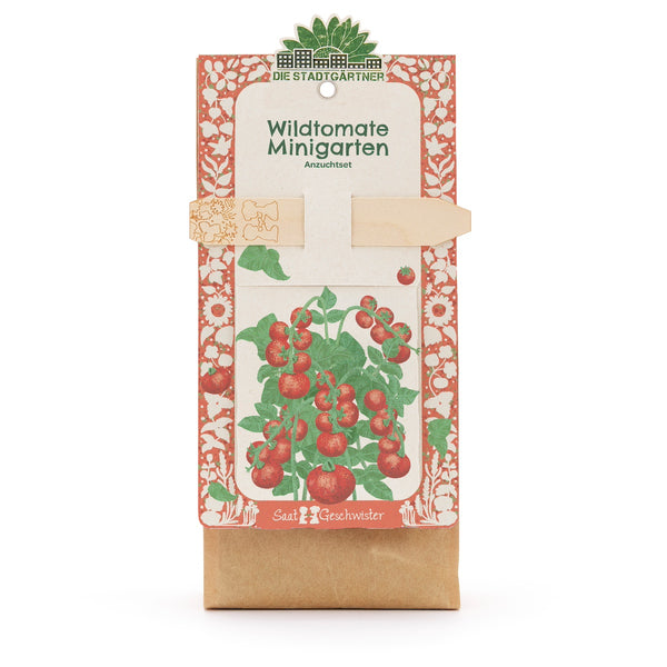 Anzuchtset âWildtomate Minigartenâ von Die StadtgÀrtner, Verpackung mit Illustration einer Tomatenpflanze und Holzstecker.