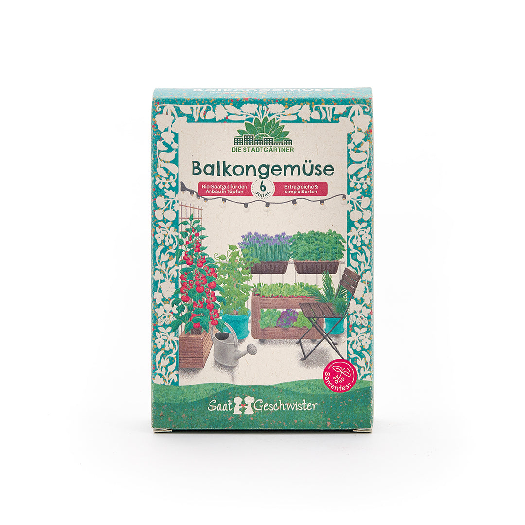 Verpackung einer Saatgutbox mit der Aufschrift "Balkongemüse" und einer Abbildung von verschiedenen Gemüsepflanzen auf einem Balkon.