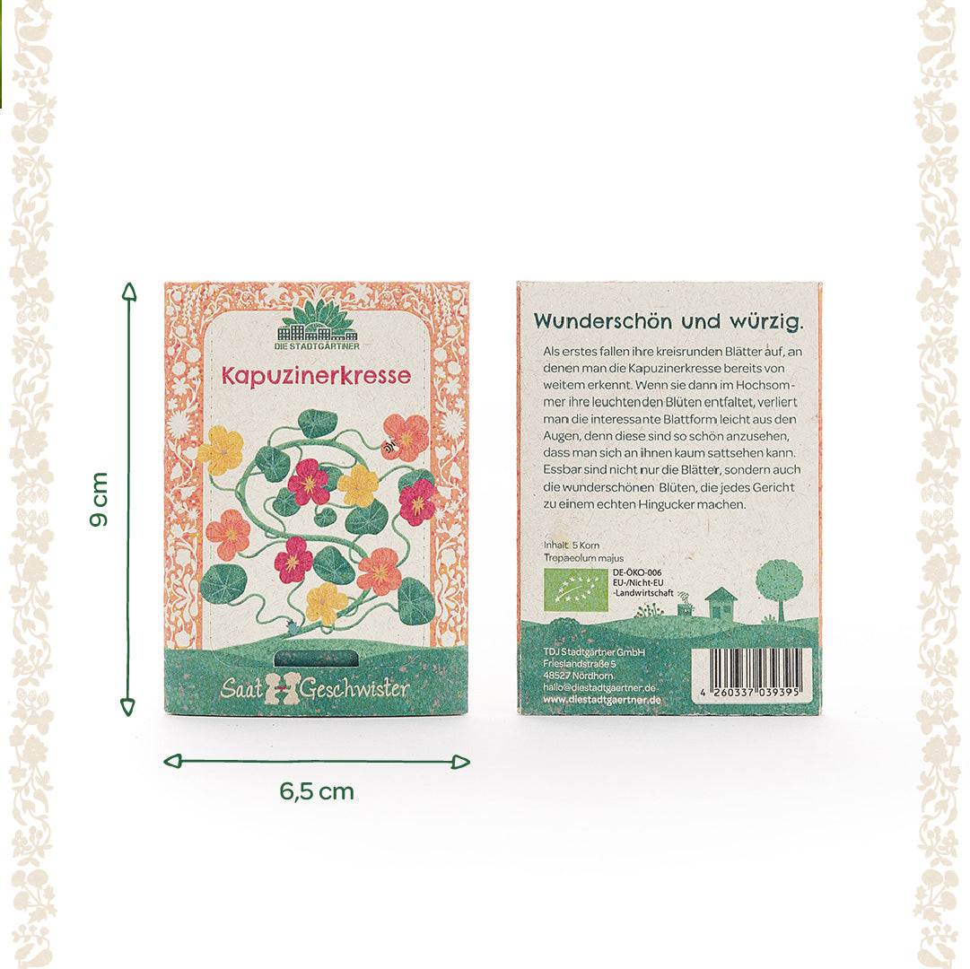 Zwei Packungen Kapuzinerkresse-Samen mit farbigen Blütenillustrationen, einer Beschreibung und Maßen von 9 x 6,5 cm auf hellem Hintergrund.